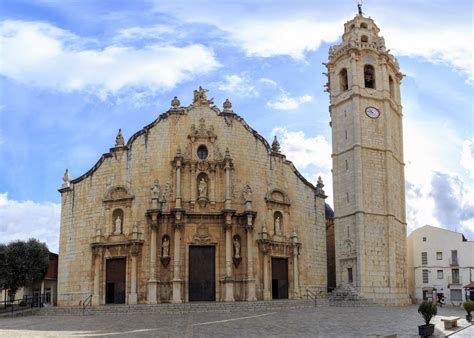 Vista exterior de la iglesia parroquial con su torre campanario y portadas renacentistas